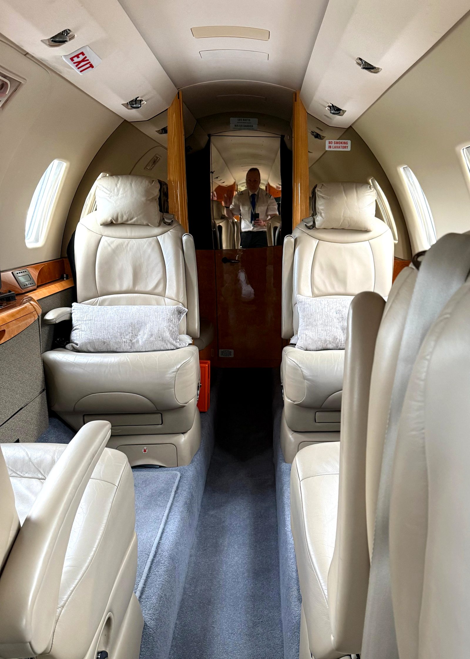 Citation X cabin looking forward toward the flight deck, double club seating in cream leather